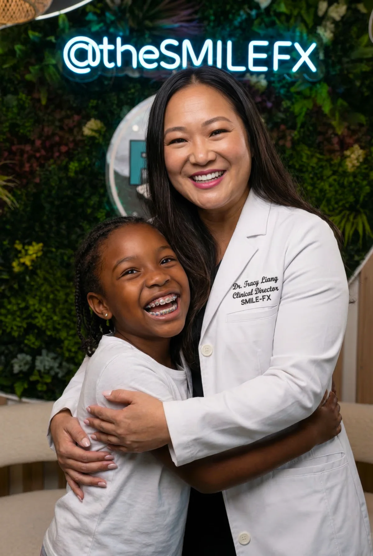 Dr. Tracy Liang hugging happy young patient at SMILE-FX