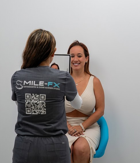Patient having orthodontic consultation at SMILE-FX studio.