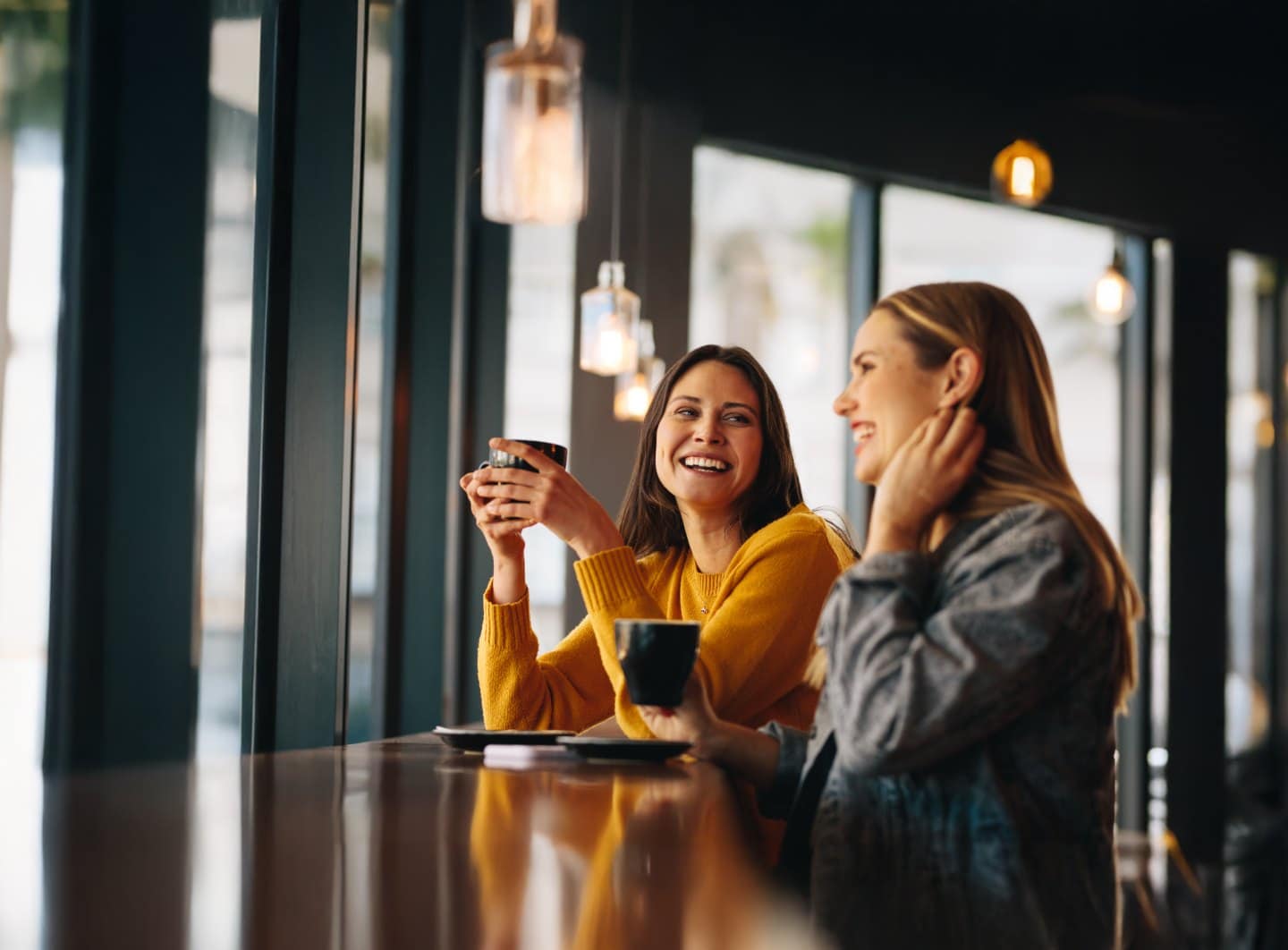 Two women enjoying coffee at SmileFX Orthodontic & Clear Aligner Studio.